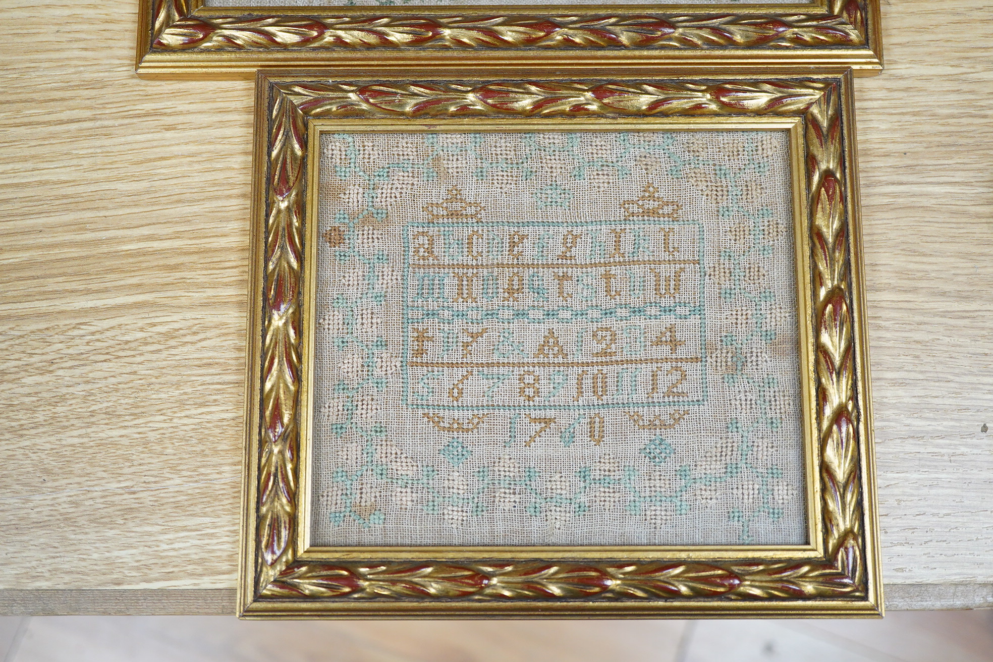 Three framed and glazed samplers, including a 1740 banded sampler by Mary Jelson, 20.5cm x 24cm, embroidered with three various verses, together with a later, smaller, alphabet sampler dated 1760, 15cm x 14cm and another
